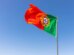 Beautiful shot of the Portuguese flag waving in the calm bright sky
